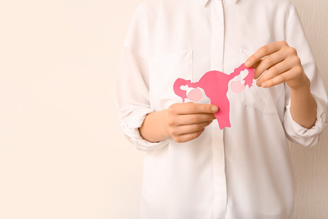 Woman with Paper Uterus on White Background, Closeup. Hormones Concept